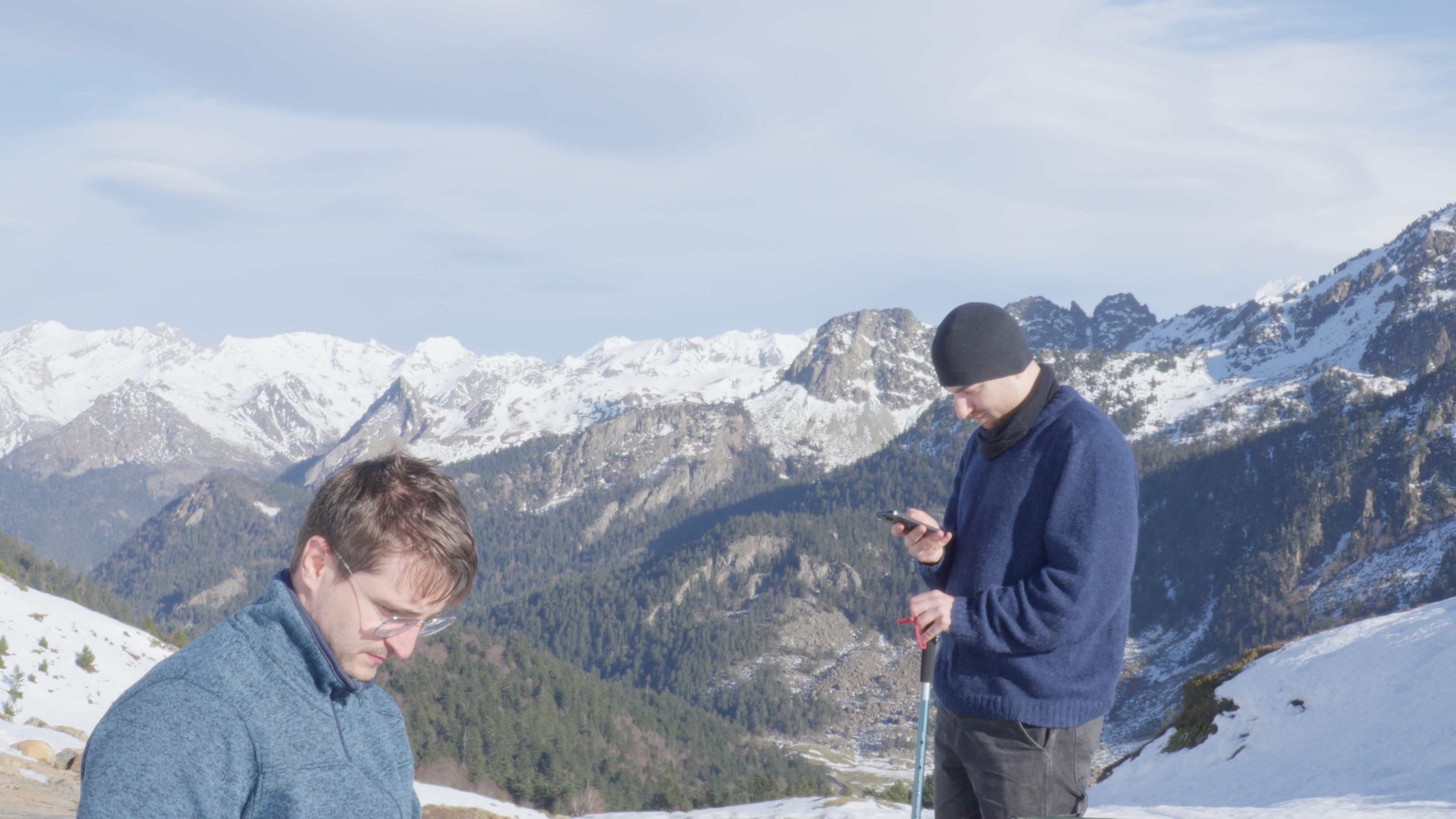 Hikers resting above a mountain valley